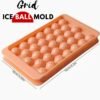 Round ice ball maker mould with dustproof lid filled with ice spheres for cocktails and drinks